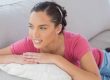 Woman on couch wondering about Vagisil cream's side effects