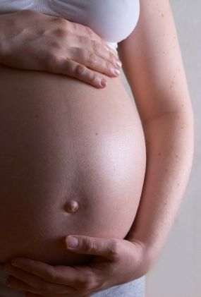 woman holding her pregnant belly