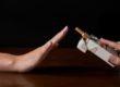 Hand saying no thanks to a packages of cigarettes offered