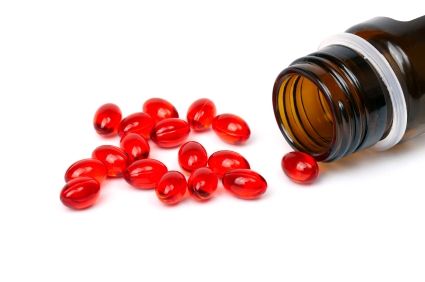 Red capsules spilling from a prescription medicine bottle