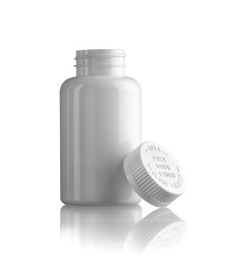 White empty medicine bottle standing with the cap at side