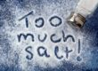 "Too much salt!" written in salt, with shaker. Warning related to diabetes, high blood pressure, etc.