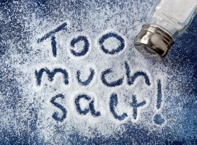 "Too much salt!" written in salt, with shaker. Warning related to diabetes, high blood pressure, etc.