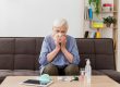 senior woman unable to prevent common cold is self-treating at home