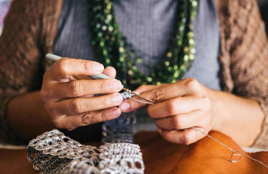 woman demonstrates how to reduce anxiety naturally through knitting