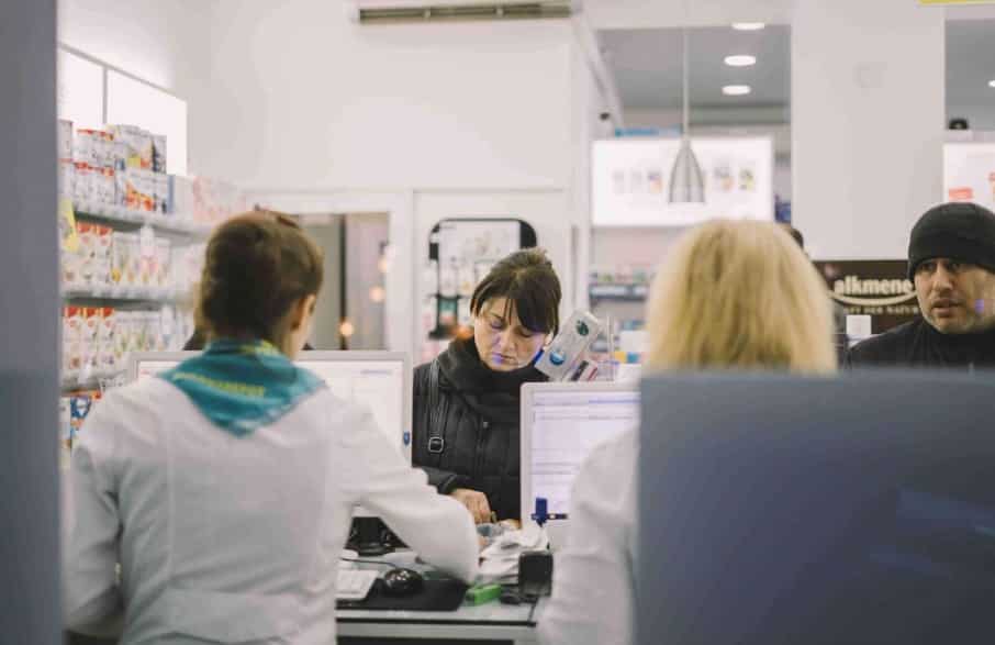 lady finding difference between Otc and prescription drugs on billing counter