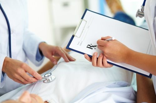 Close-up of female doctors hands during medical treatment of patient in hospital