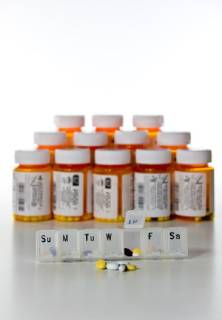 Vertical set of prescription drug bottles