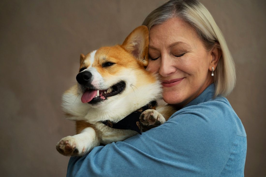 Senior woman tenderly holding a small pet dog - Tresaderm for dogs