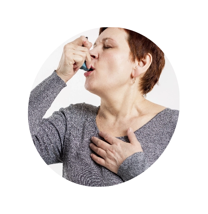 Woman inhaling from asthma pump.