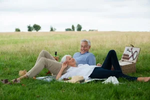 senior couple having a picnic at a park