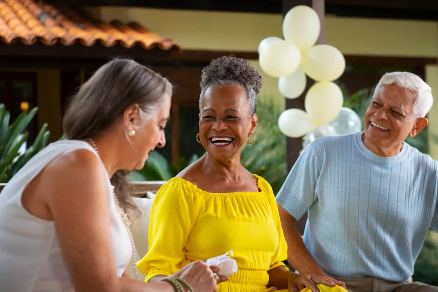 Three happy seniors laughing together while discussing Jardiance cost savings