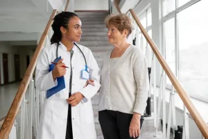 A doctor and a senior patient engaging in a conversation about their treatment plan, likely concerning Eliquis and pain medication considerations