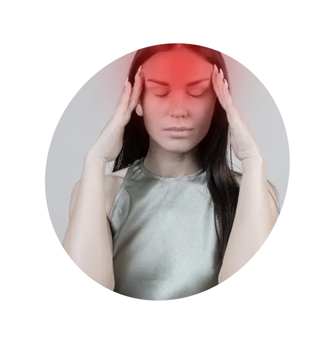 A woman holding her forehead as she experiences a Migraine headache