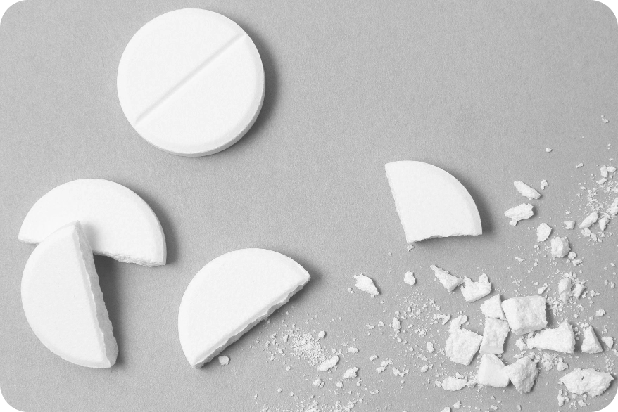 An image depicting a whole and crushed white tablet relevant to medical conditions