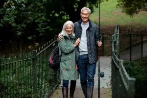 Older couple walking outdoors while discussing whether Farxiga lowers blood pressureAn older couple walking together outdoors, representing questions about whether Farxiga (dapagliflozin) can lower blood pressure.